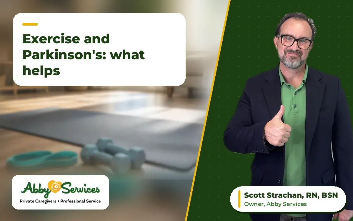 Scott Strachan, RN, BSN, owner of Abby Services, giving a thumbs up, with light hand weights, a resistance band and an exercise mat in the background