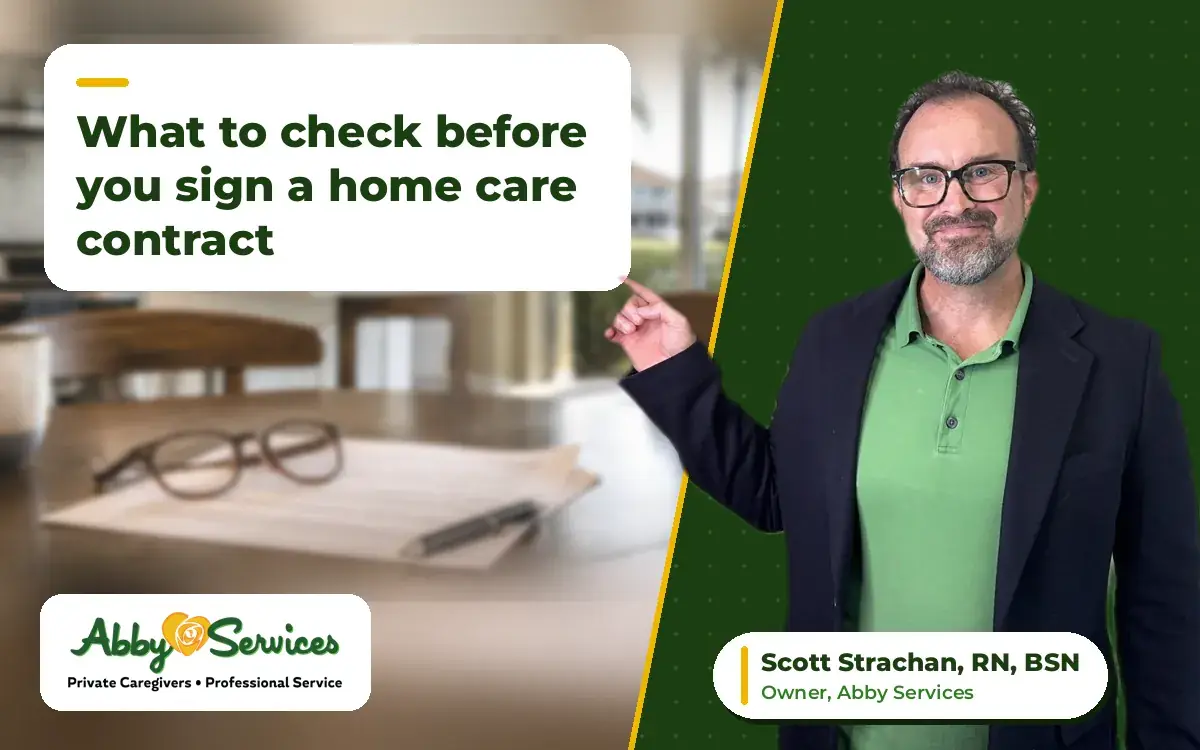 Scott Strachan, RN, BSN, owner of Abby Services, pointing to the article title, with a home care agreement, reading glasses and a pen on a kitchen table