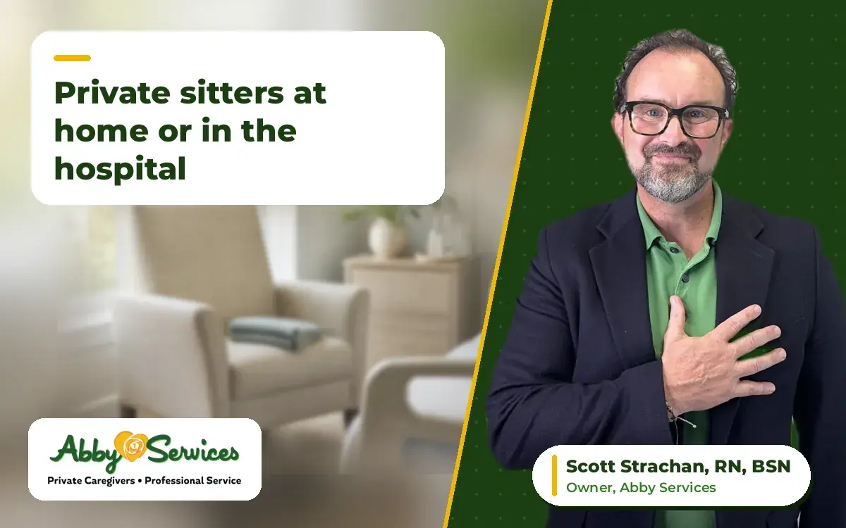 Scott Strachan, RN, BSN, owner of Abby Services, with his hand on his heart, with an armchair beside a hospital bed near a sunny window in the background